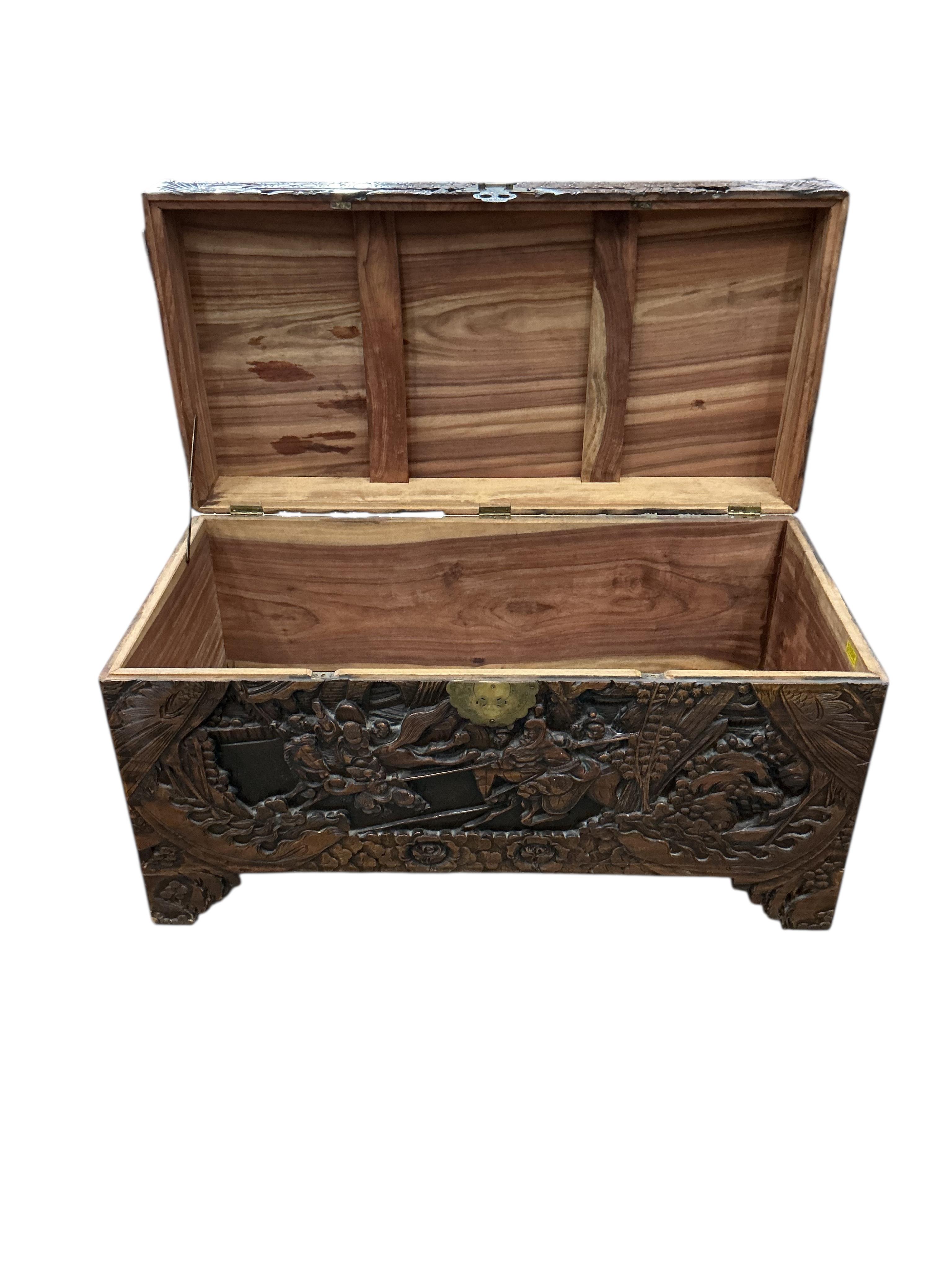 A Chinese carved camphorwood trunk, width 97cm, depth 47cm, height 54cm
